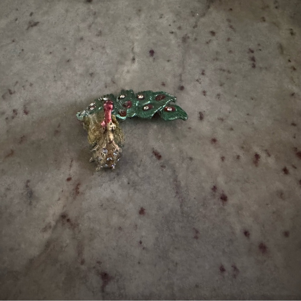 A small standing peacock, turquoise and gold trinket
